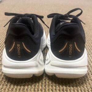 Hoka Black and White Sneakers with Gold Accents